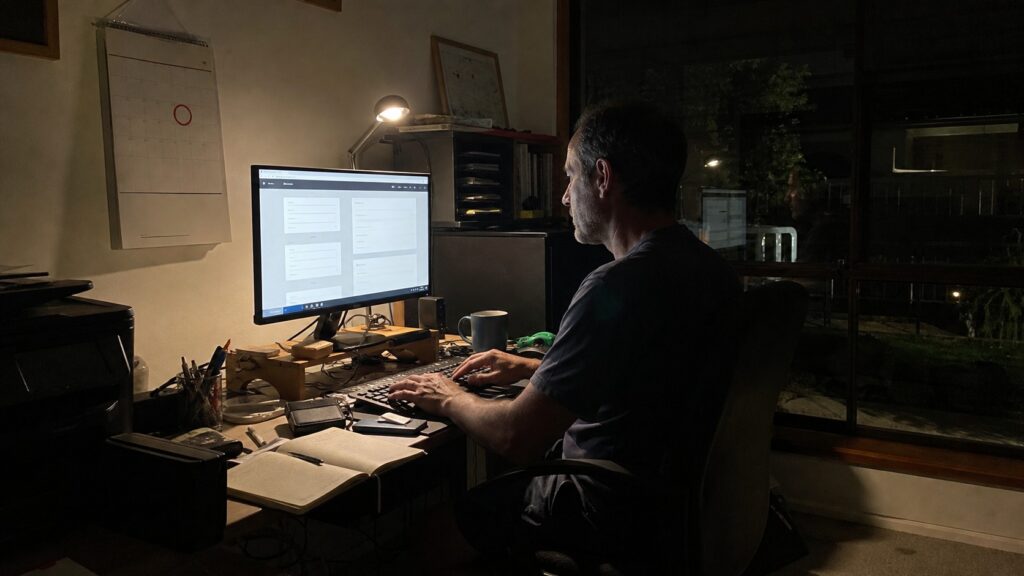 hands updating domain registration details at a home office desk to meet the 2026 au domain rules