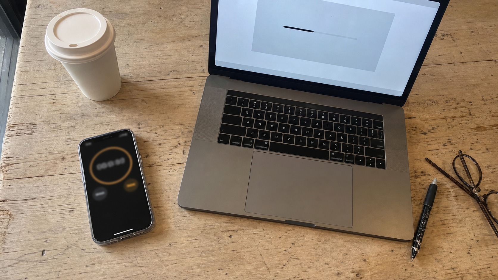 Measuring Core Web Vitals WordPress page speed with a phone stopwatch beside a laptop